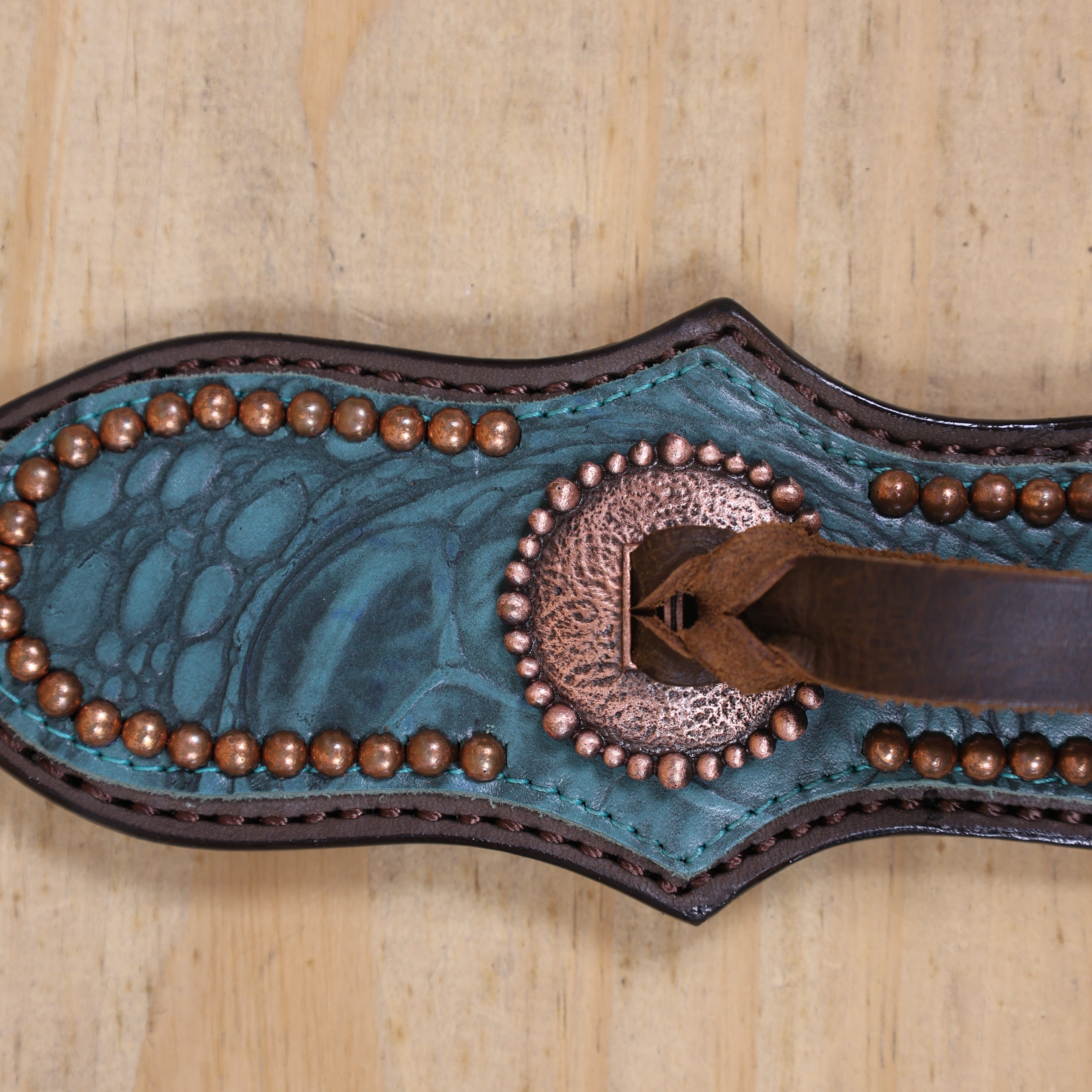 Western leather headstall with matching breast collar featuring copper slot conchos