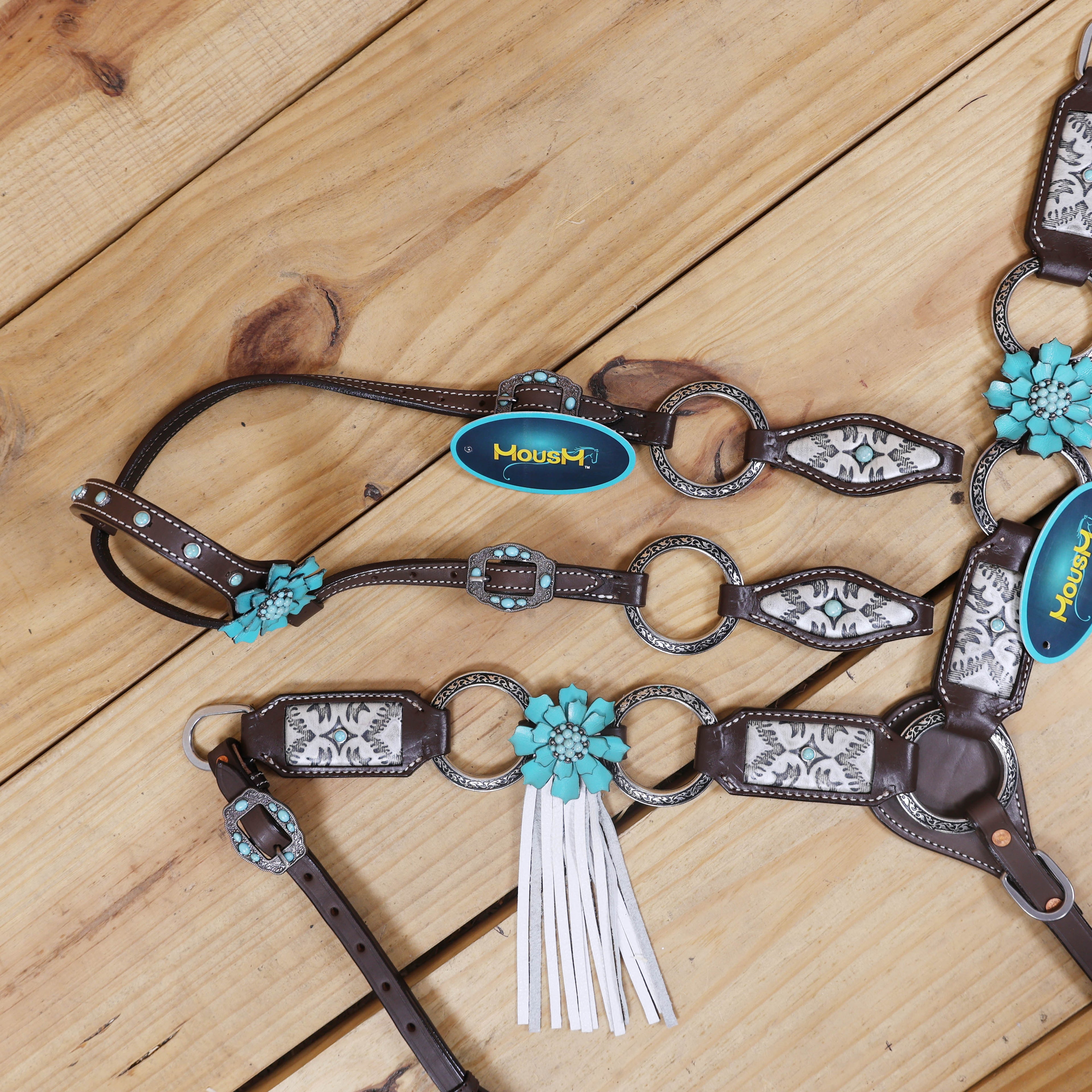 horse headstall with engraved rings and leather inlay on cheekpiece breast collar and one ear