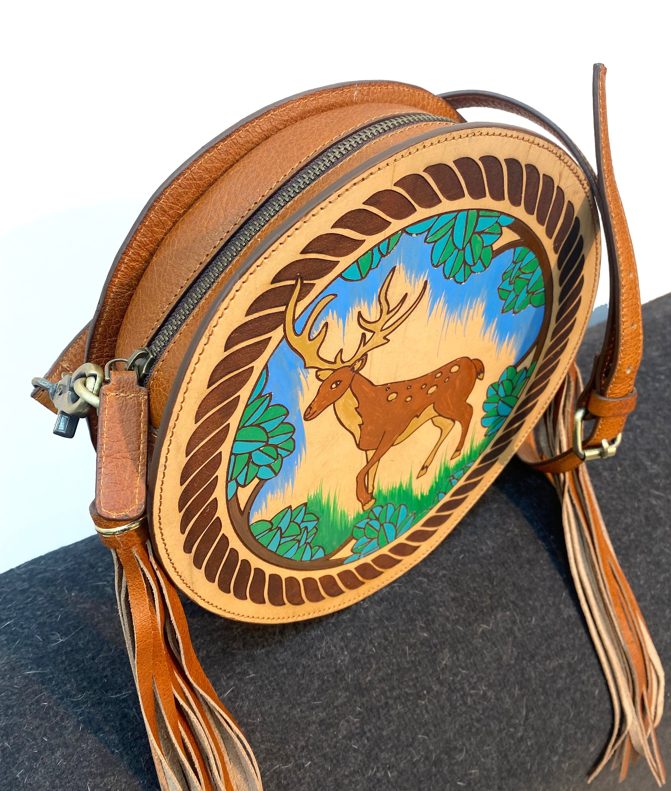 MOUSM Full Grain Cow Hide Leather Crossbody Bag - Small Round Ladies Bag Decorated with Hand-Painted Deer in Forest Carving with Rope Border & Leather Tassel Fringe, High-Quality Zipper Closure with Removable and Adjustable Strap