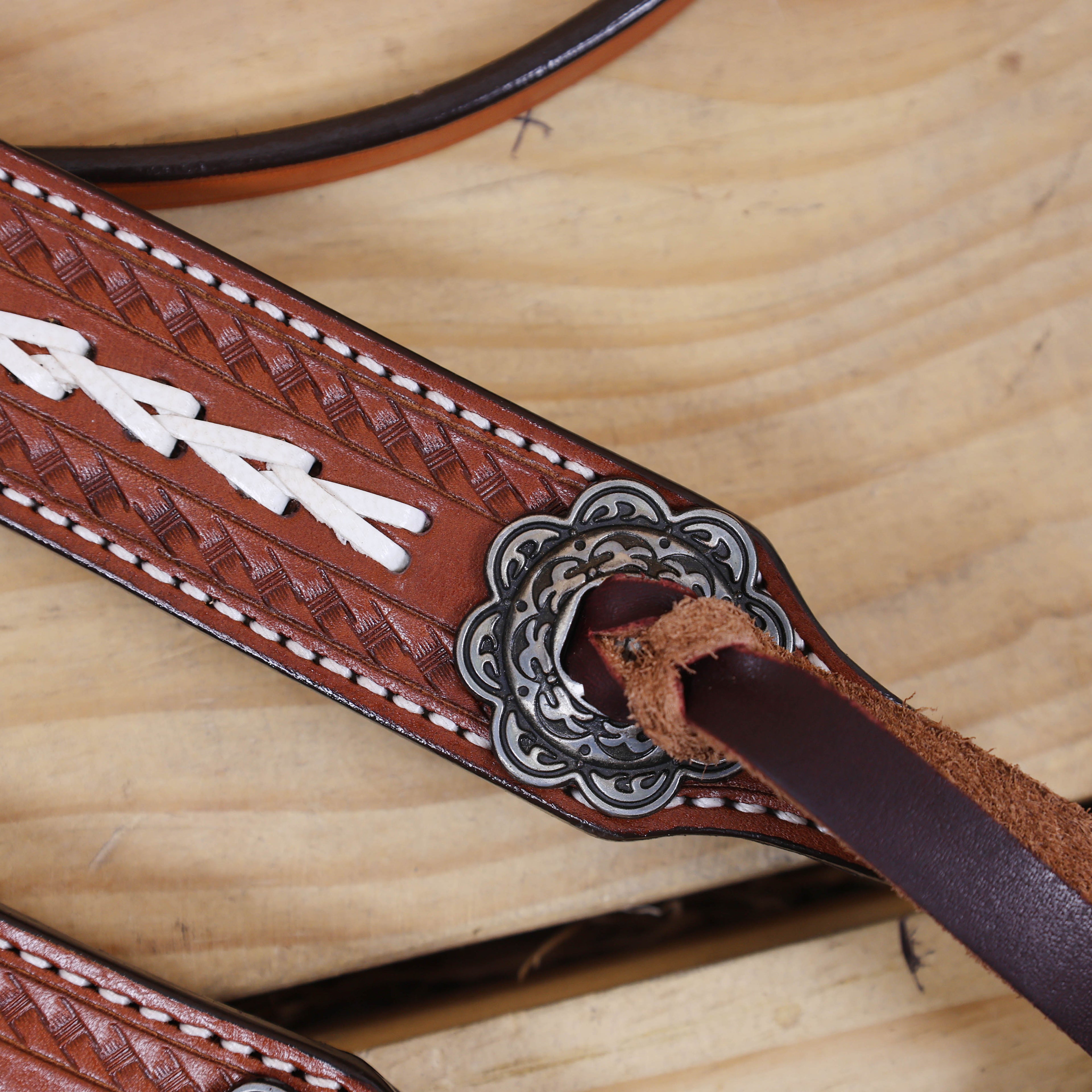 antique nickel slot conchos with burgundy leashes and basket tooling