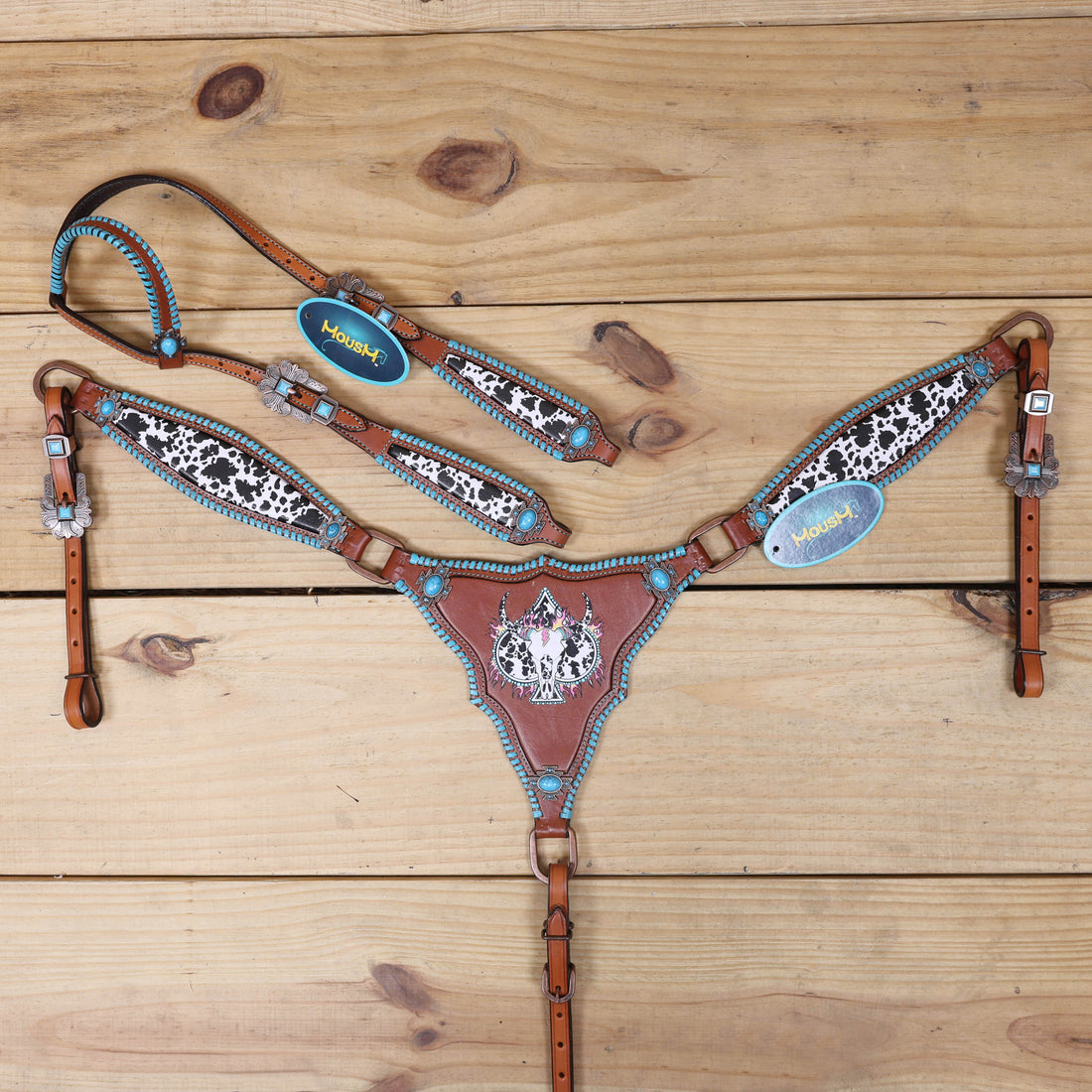 western tack set with cowhide print, turquoise rawhide stitching, steer head design, and spade symbols
