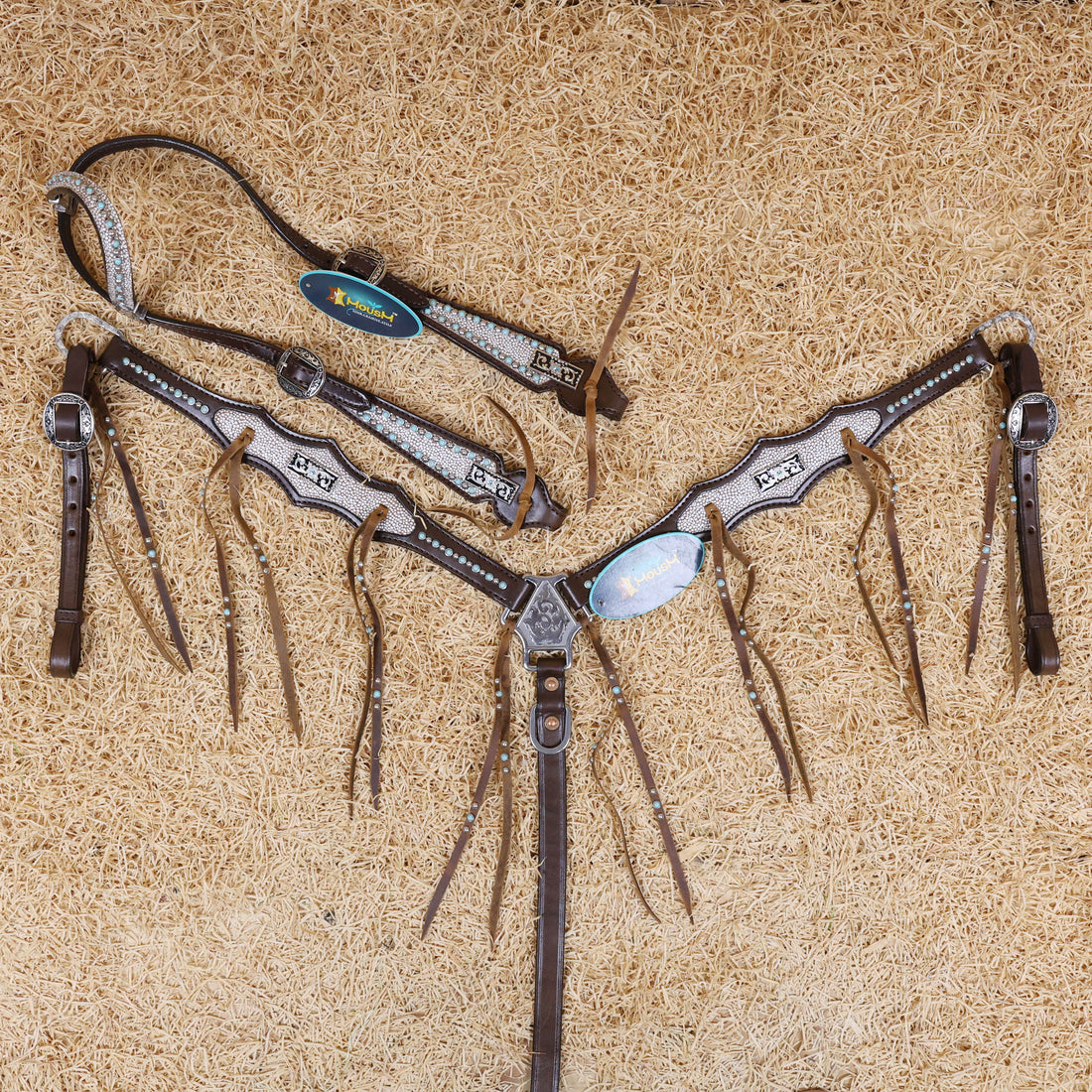 A fringe headstall and breast collar set for a horse, made of genuine cowhide leather with antique copper conchos, turquoise and nickel studs, displayed on a textured background.