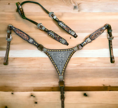 A set of Argentina cow leather Western horse tack, featuring a breast collar and headstall with grey alligator and filigree carving, and thunderbird hardware.