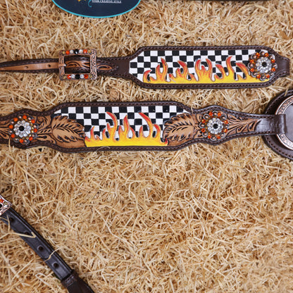 Decorative headstall with checkered pattern and flame design on a hay background