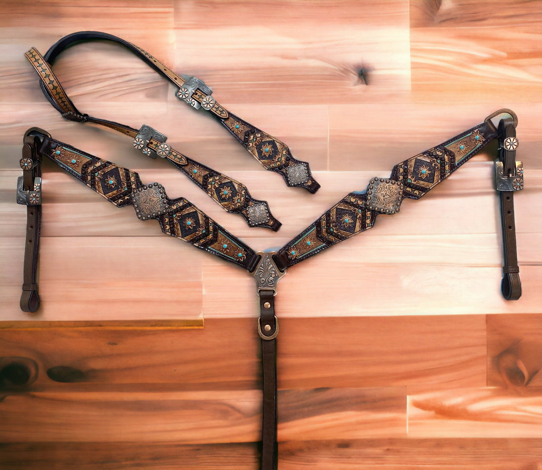 A Argentina cow leather headstall and breast collar set for horse, featuring geometrical flower carving and antique copper conchos on a wooden surface.