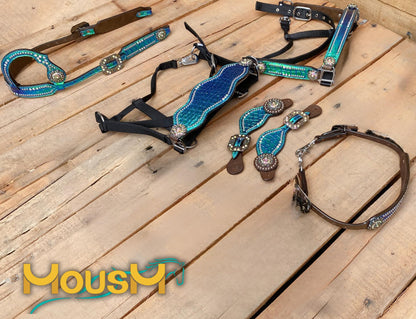 A set of Argentina cow leather horse tack including a headstall, breast collar, and other matching accessories, featuring a metallic turquoise holographic alligator print.