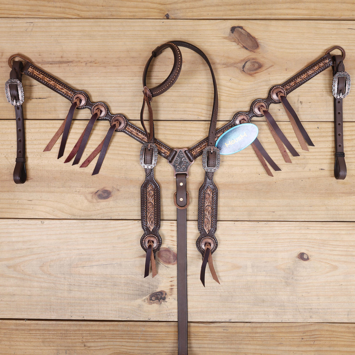 western leather tack set with hand-carved border, copper studs, and burgundy leather laces