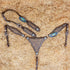 Argentina cow leather horse bridle and breast collar set with leopard print design, silver studs, and antique copper hardware, displayed on a bed of straw.