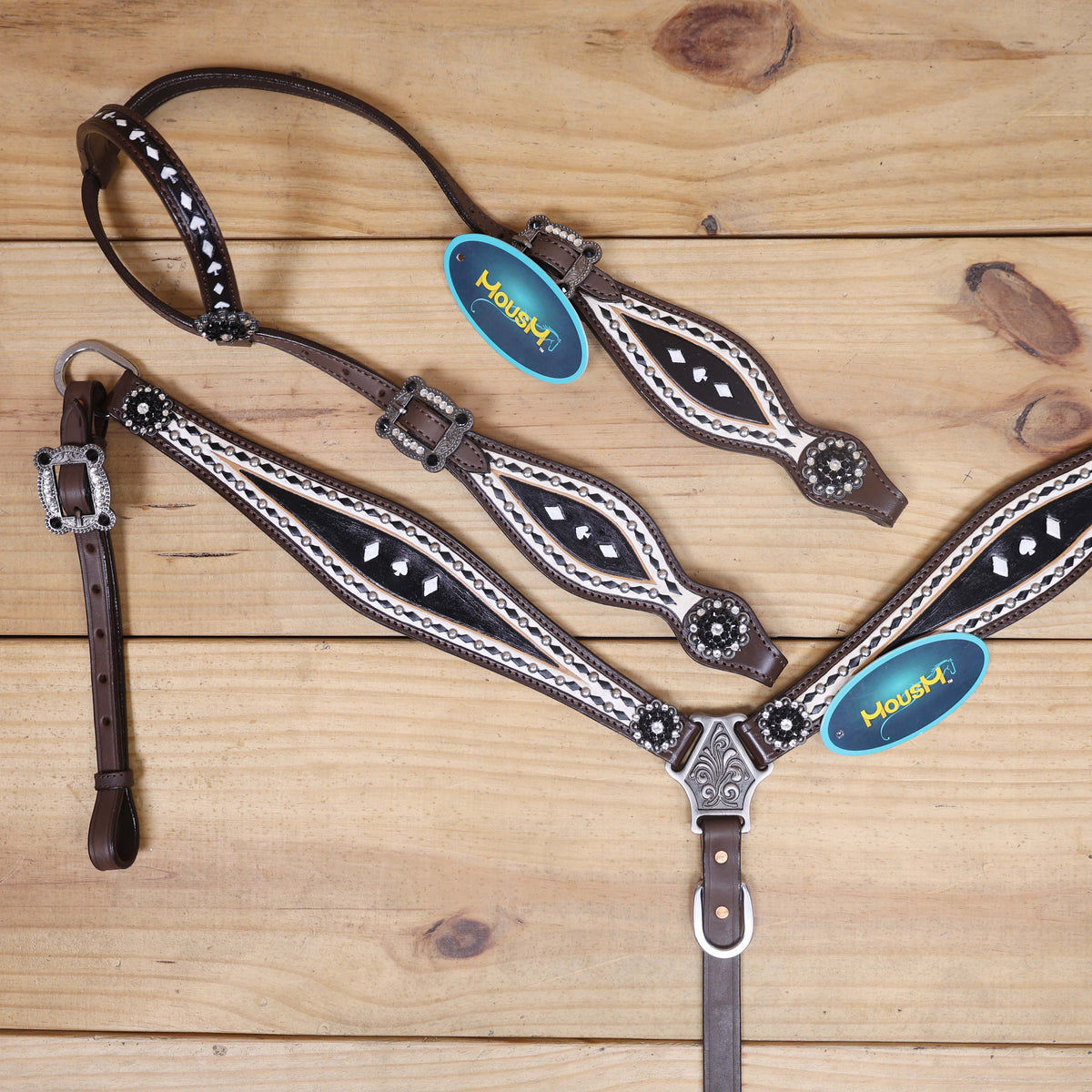 western tack with black rawhide braiding and rhinestone conchos
