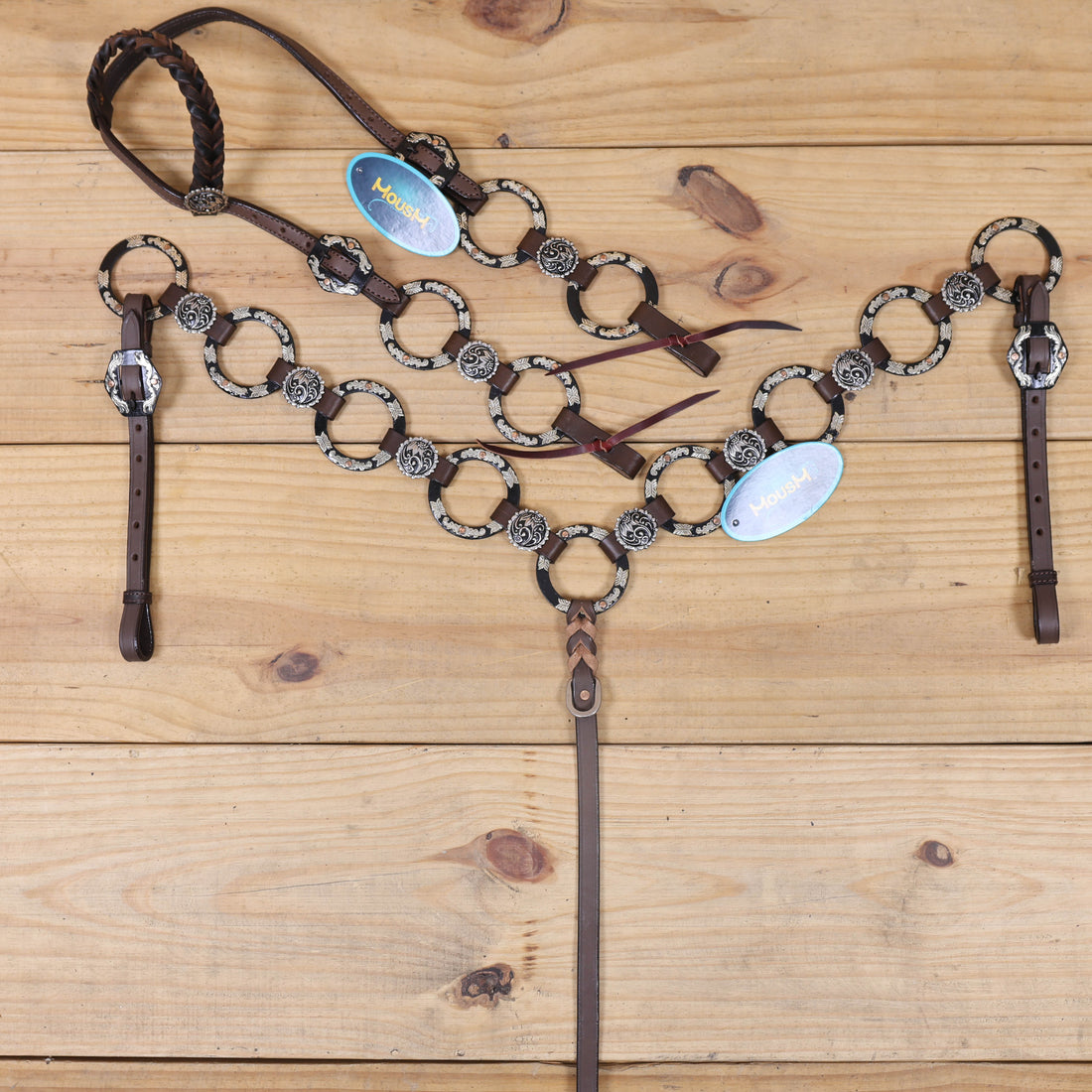 handcrafted western tack set with raw leather laces, engraved floral conchos, and nickel rings
