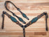 A complete Western horse tack set laid out on a wooden surface, featuring a teal alligator design with hand-tooled flower craving and antique copper hardware.