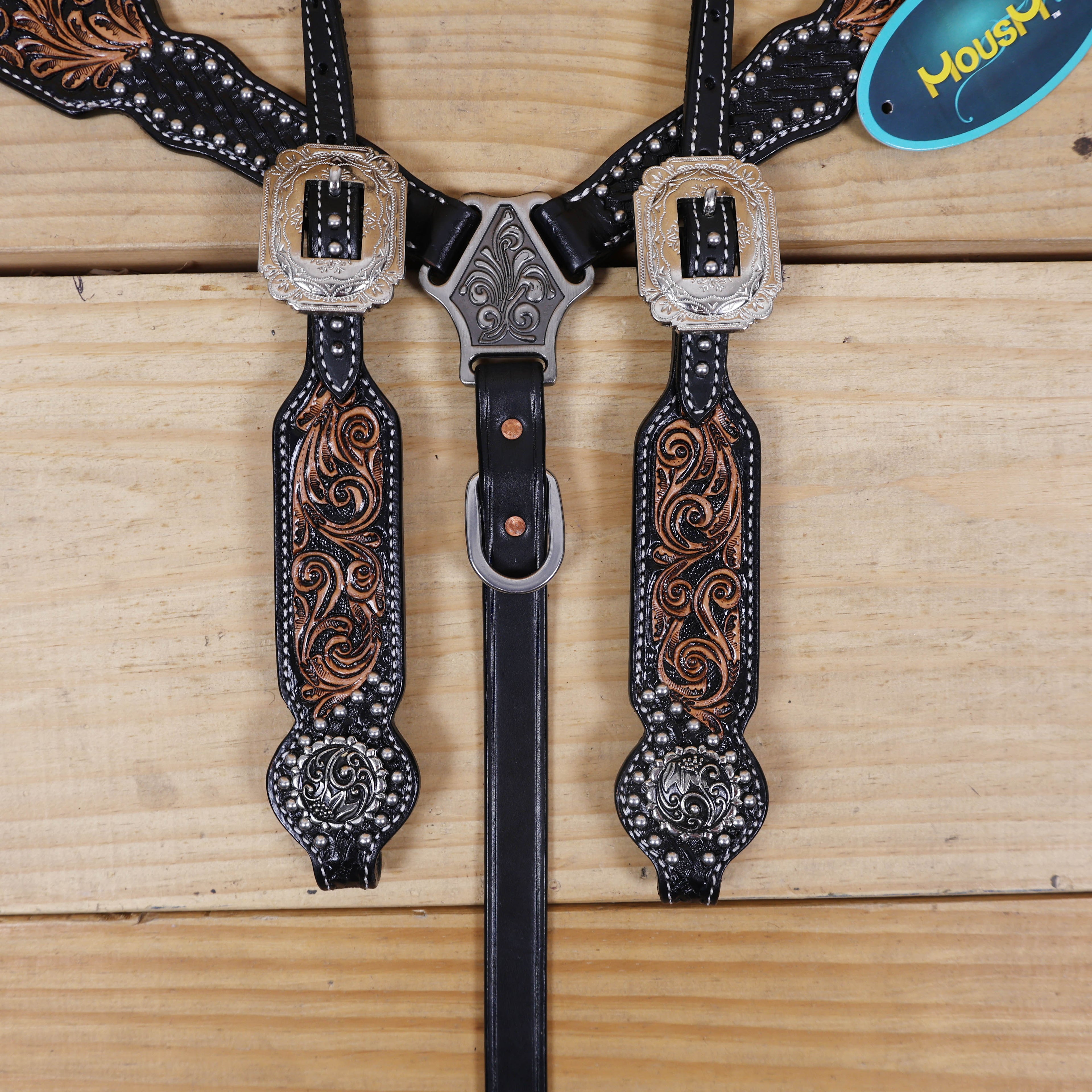 hand tooled black leather cheekpiece with silver studded floral tooling