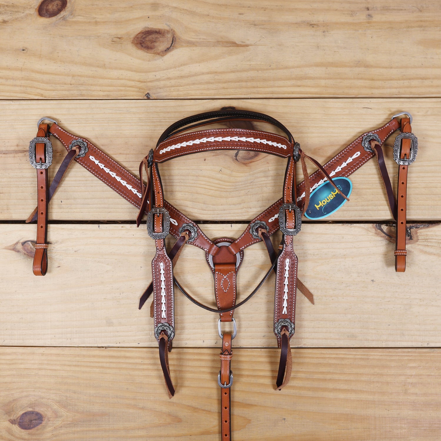 western headstall and breast collar featuring arrow-style rawhide braiding and antique nickel hardware
