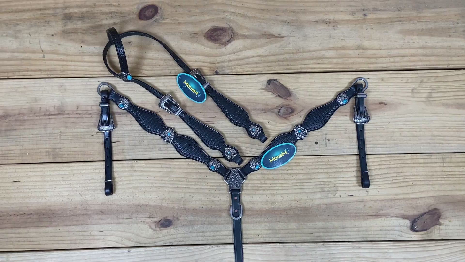 western headstall and breast collar set in deep black leather with crisscross rawhide braiding and turquoise jewel hardware