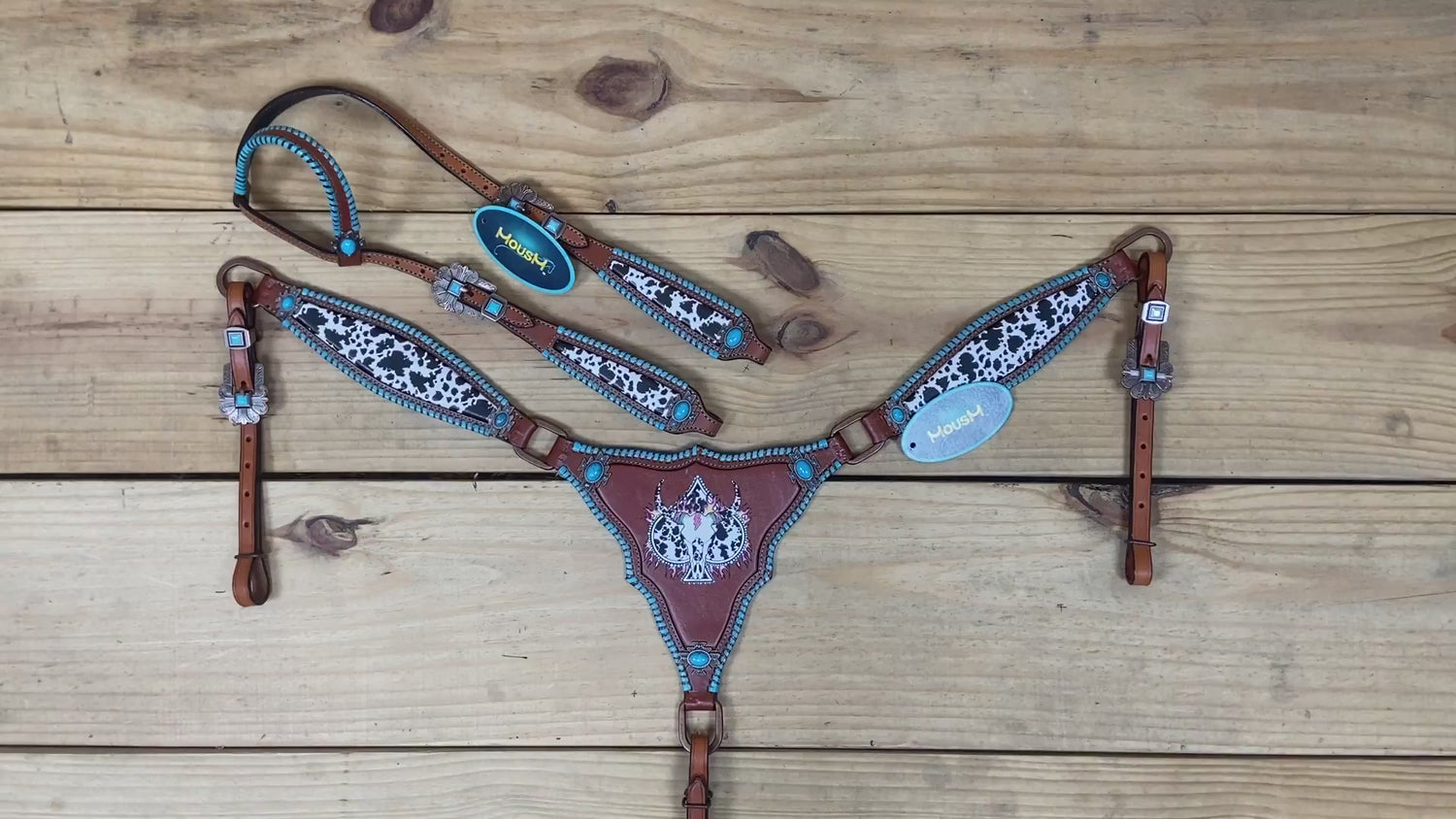 western headstall and breast collar with cowhide theme, turquoise hardware, and detailed rawhide stitching all over